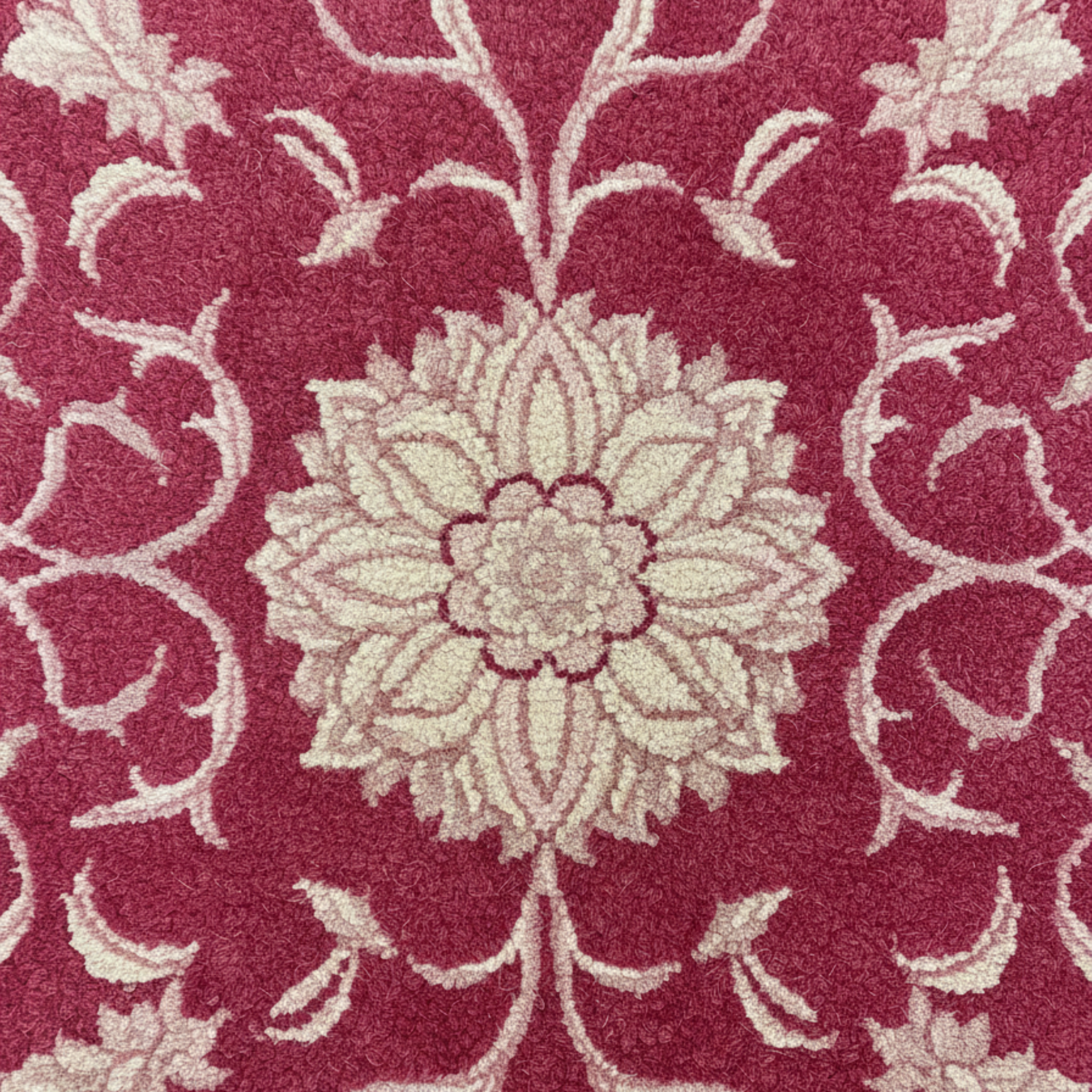 Floral patterned rug with beige flowers on a red background