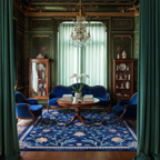 a traditional green living room with blue furniture and Navy Chinoiserie Bloom Viscose Hand Tufted Rug