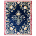 Decorative rug with floral and paisley pattern on a blue background
