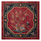 Decorative rug with floral and bird design on a red background
