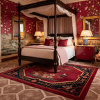 Decorative chinoiserie bedroom with red walls, floral red rug, and a four-poster bed.