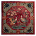 Decorative rug with crane design on a red background