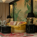 Luxurious living room with yellow sofa, decorative pillows, a red rug, and a large wall mural.